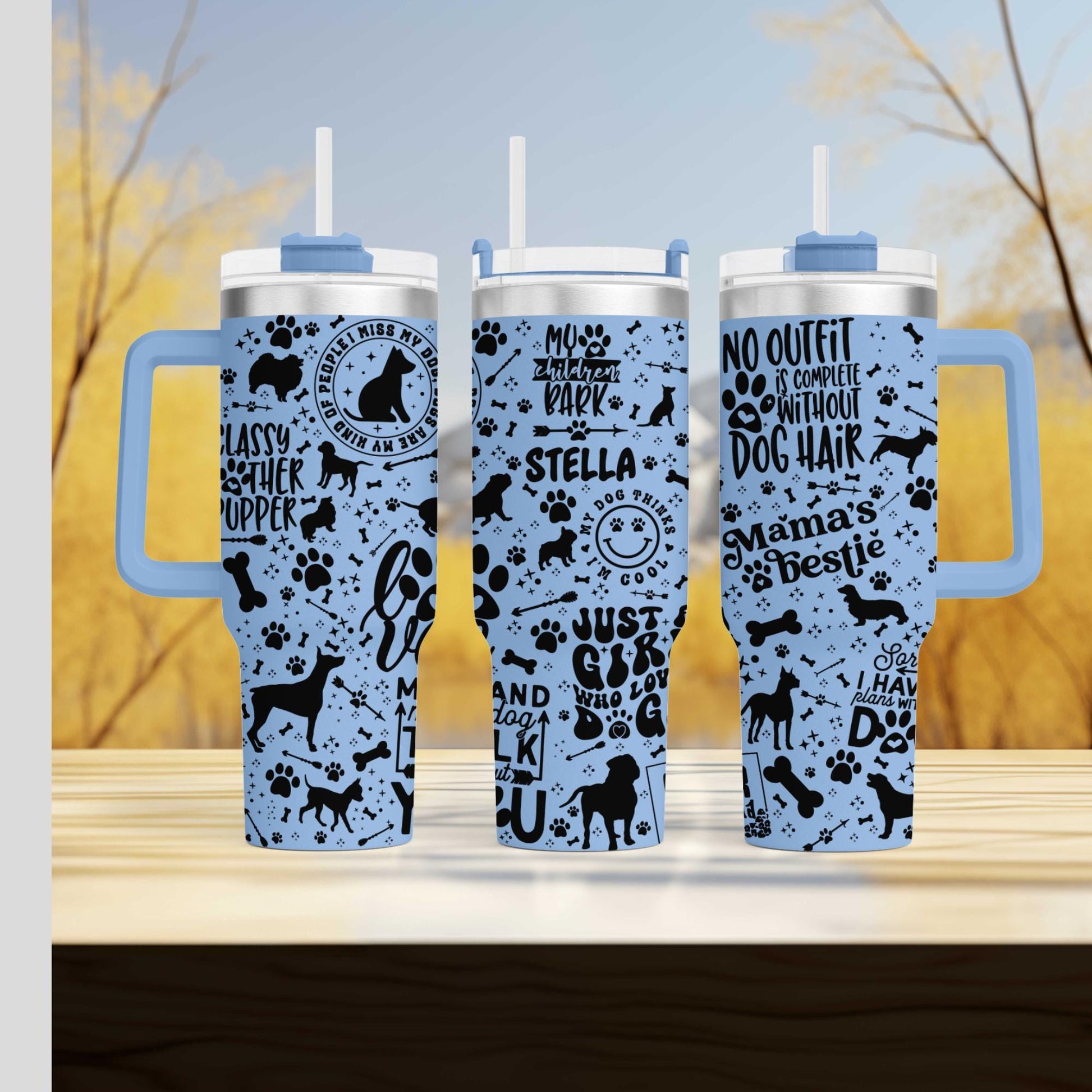 three travel mugs sitting on top of a wooden table