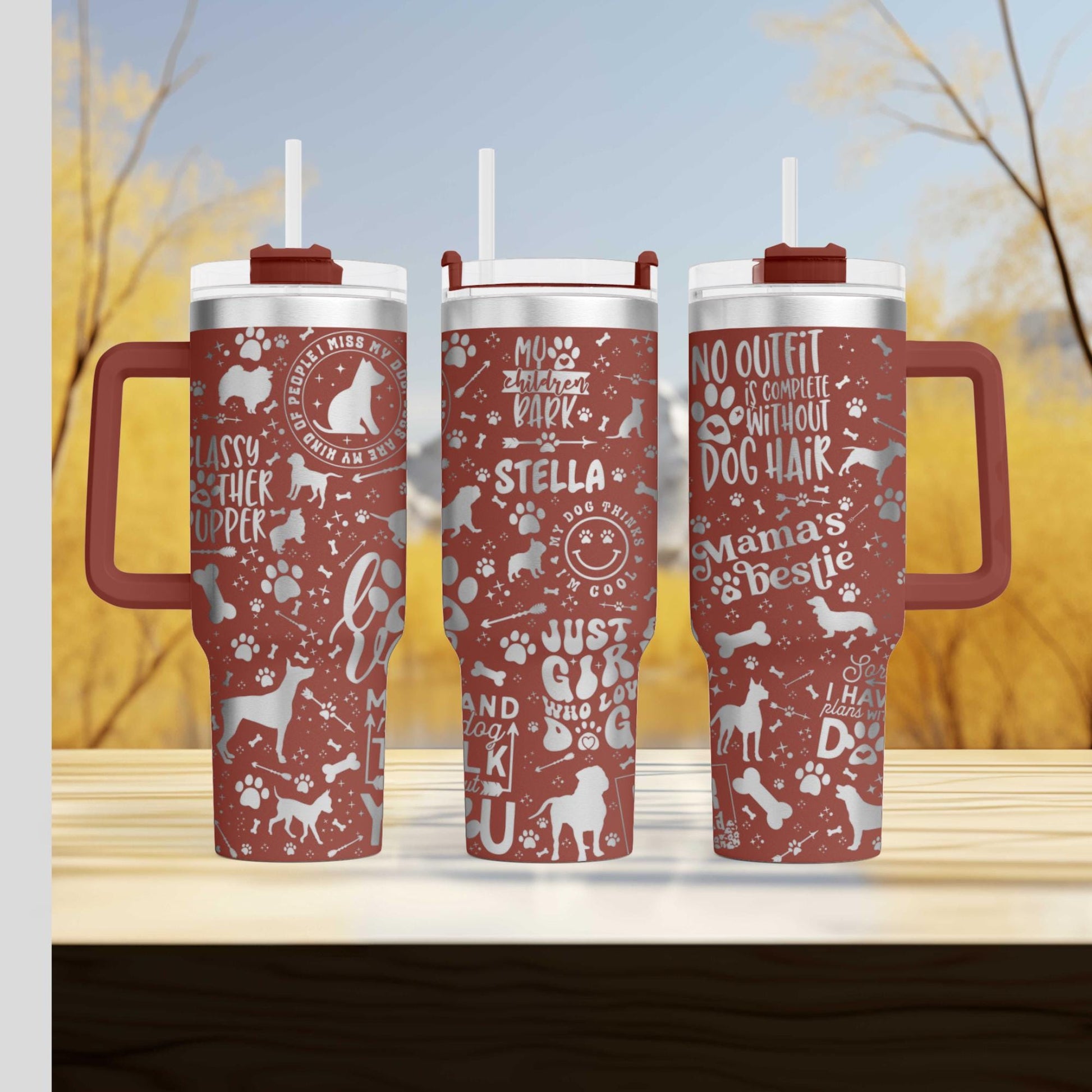 three red travel mugs sitting on top of a wooden table