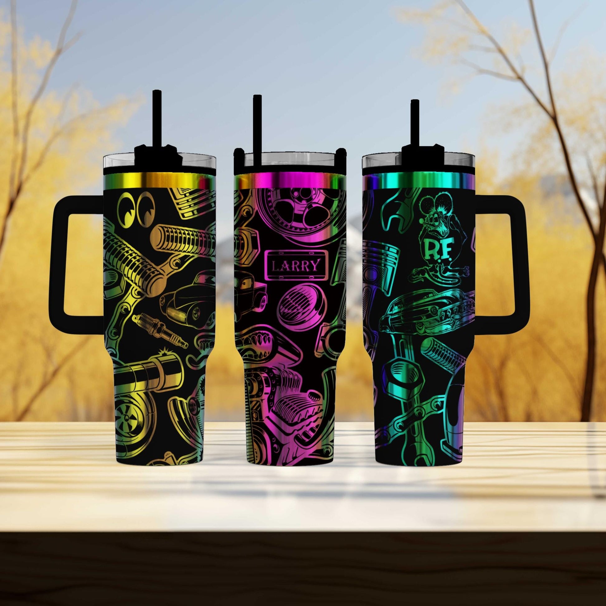 three colorful tumblers sitting on top of a wooden table