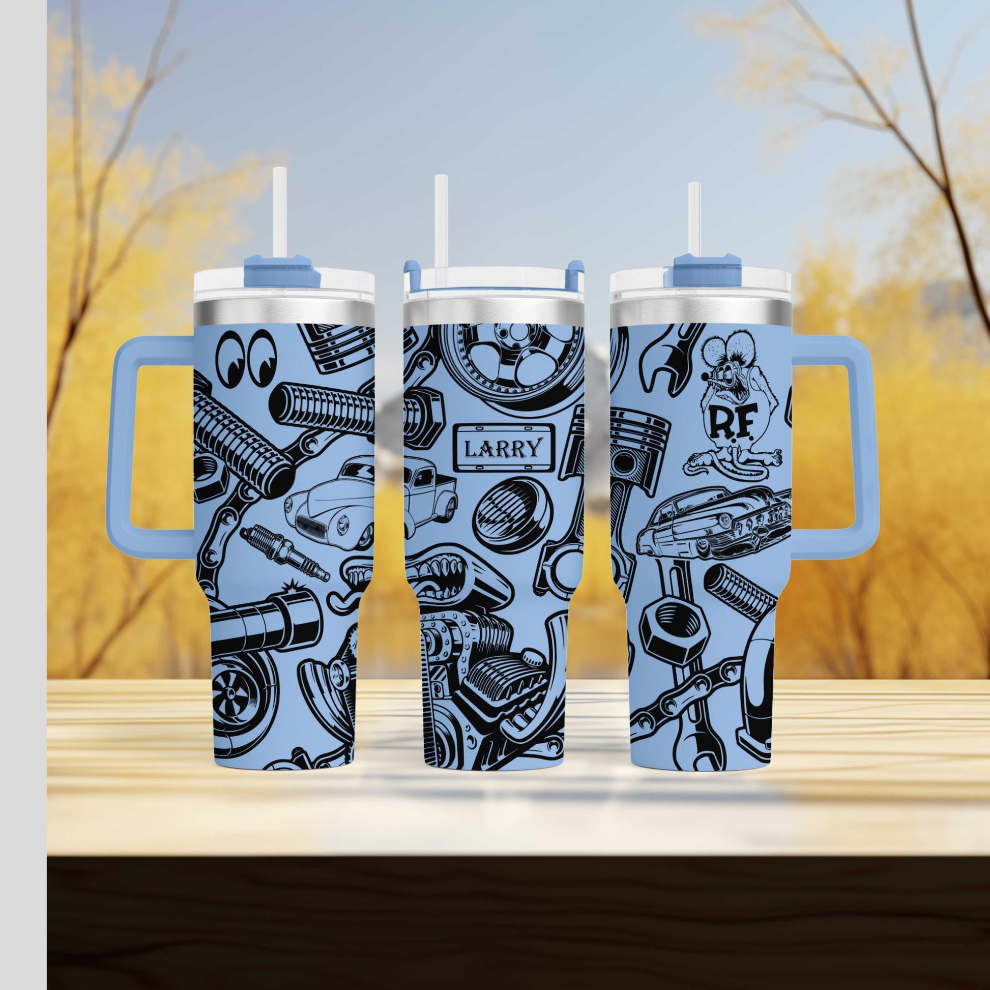three travel mugs sitting on top of a wooden table