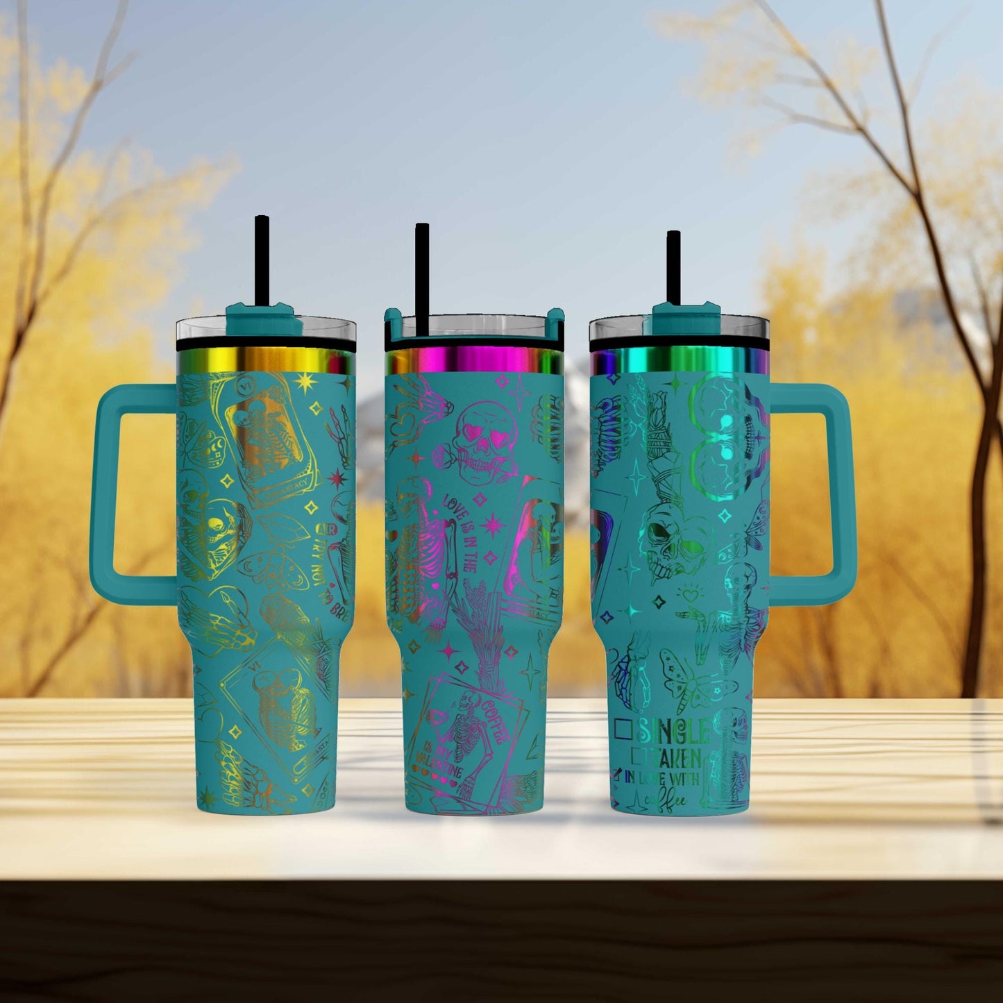 three different colored tumblers sitting on a table