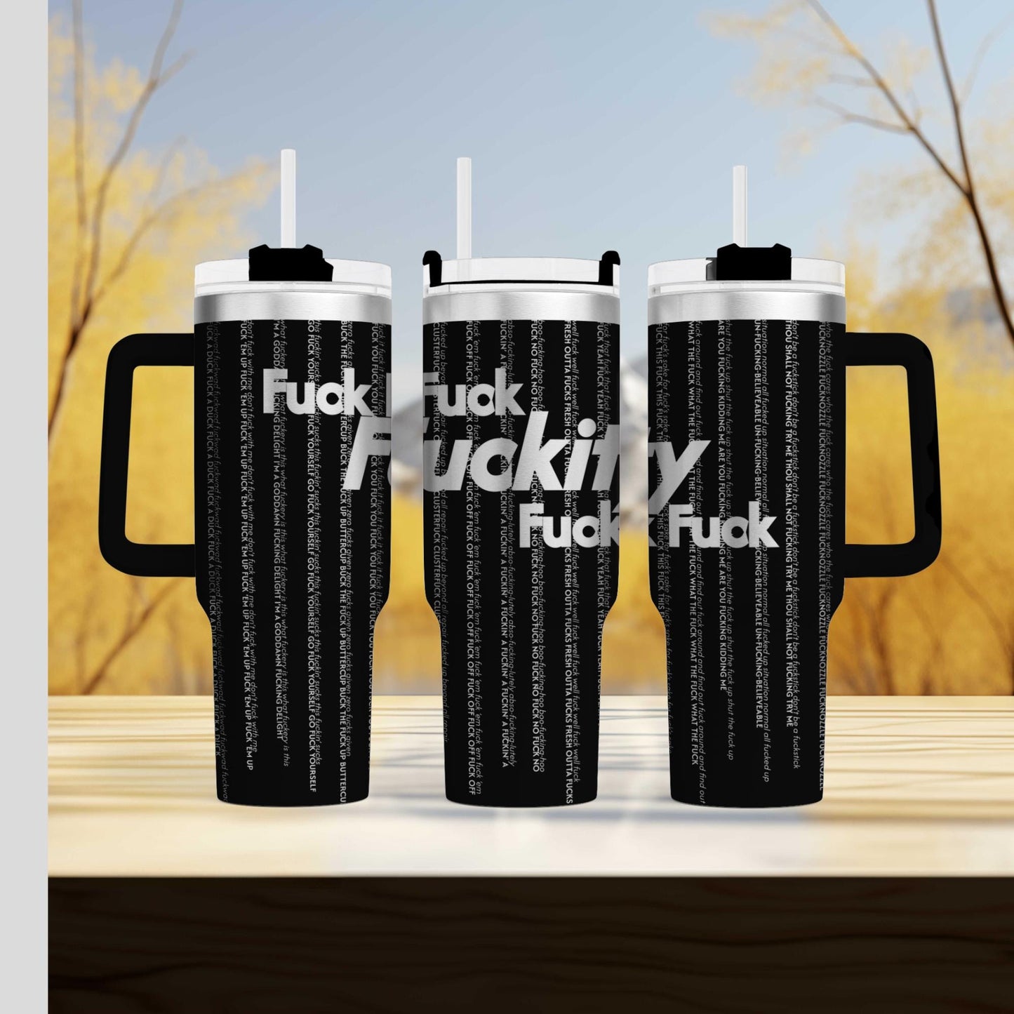 a couple of black cups sitting on top of a wooden table