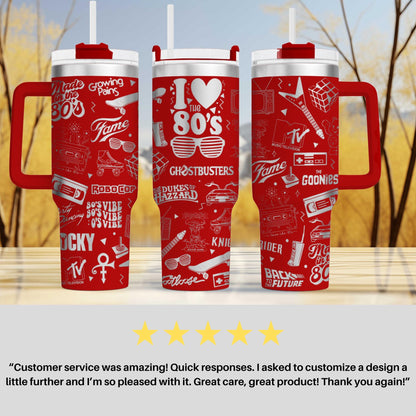 three red travel mugs sitting on top of a table