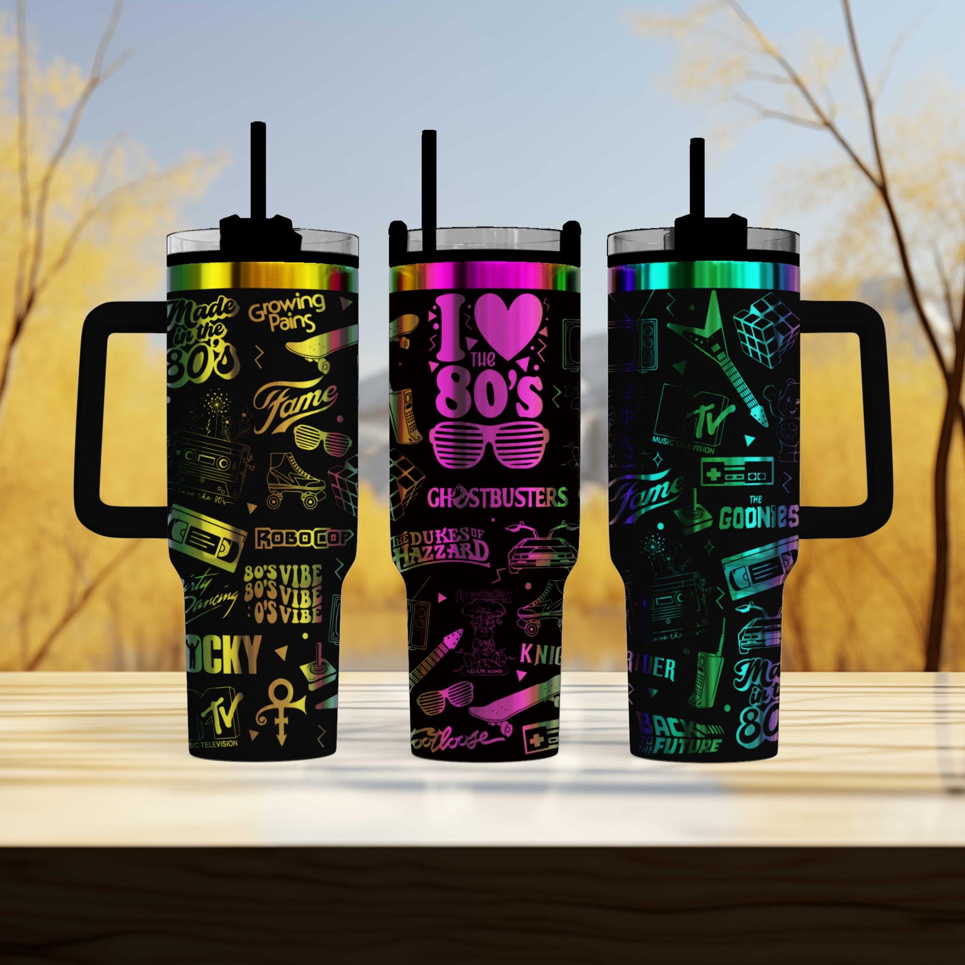 three travel mugs sitting on top of a wooden table