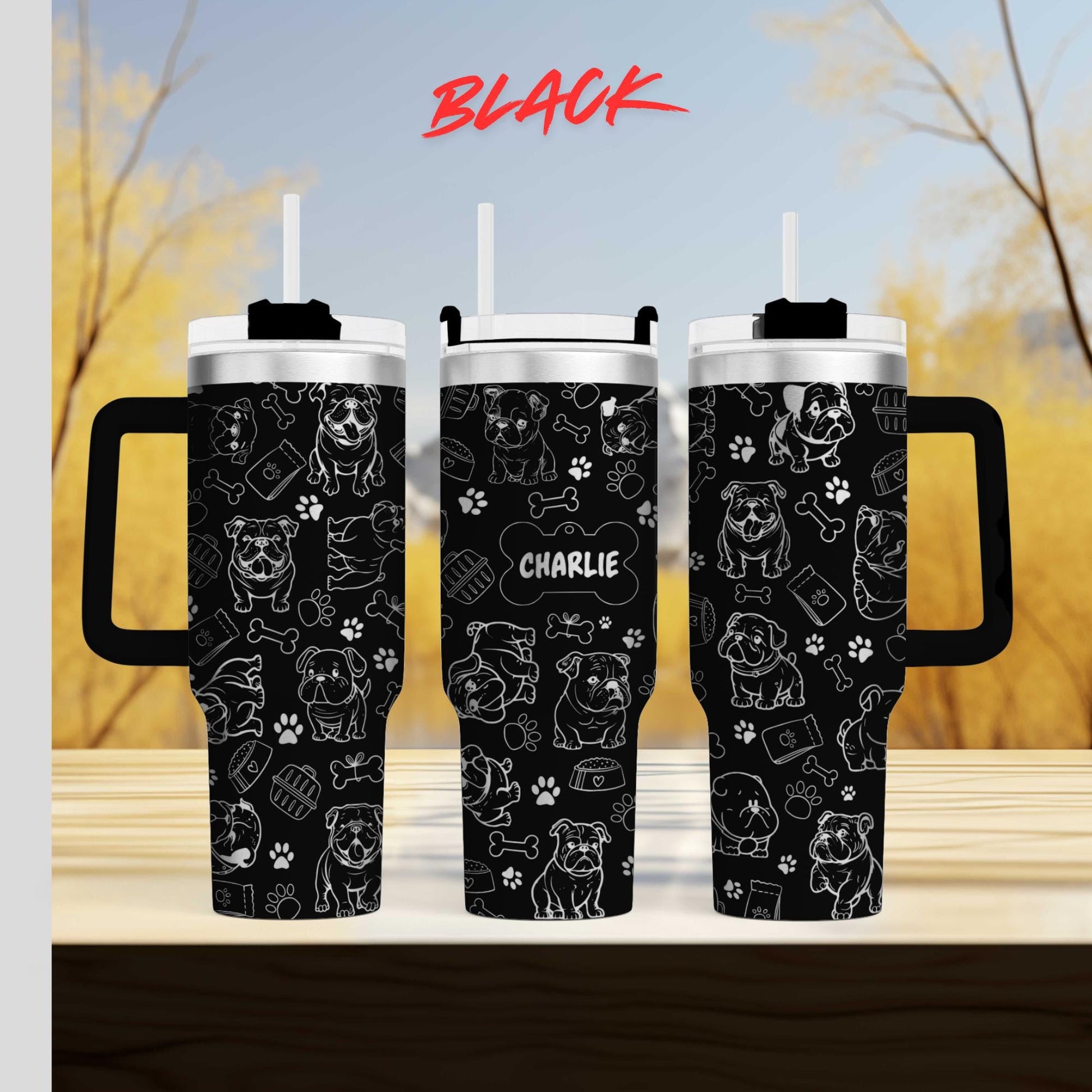 a couple of black cups sitting on top of a wooden table