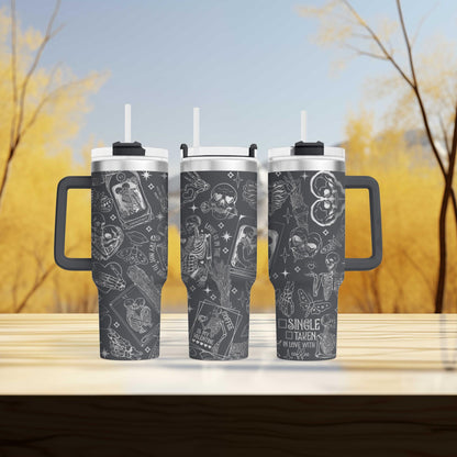 three travel mugs sitting on top of a wooden table