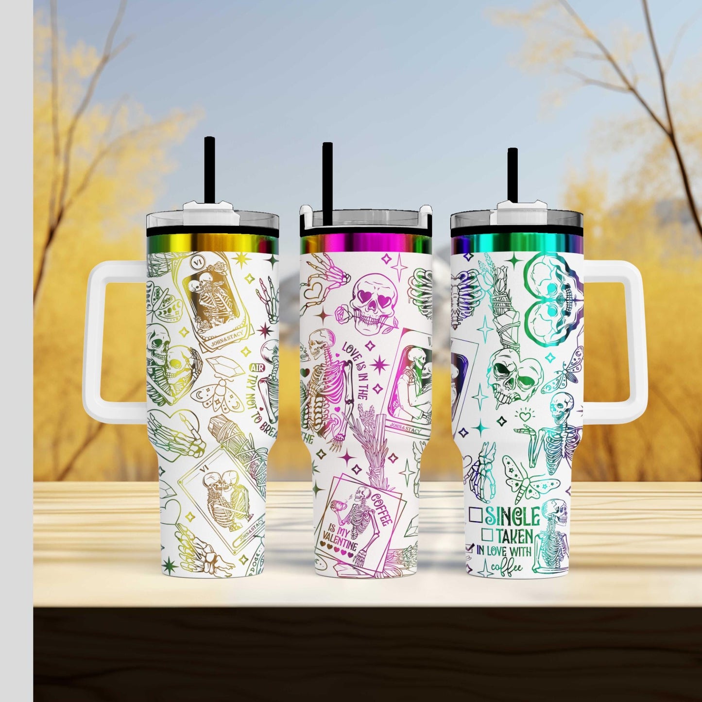 a group of three travel mugs sitting on top of a wooden table