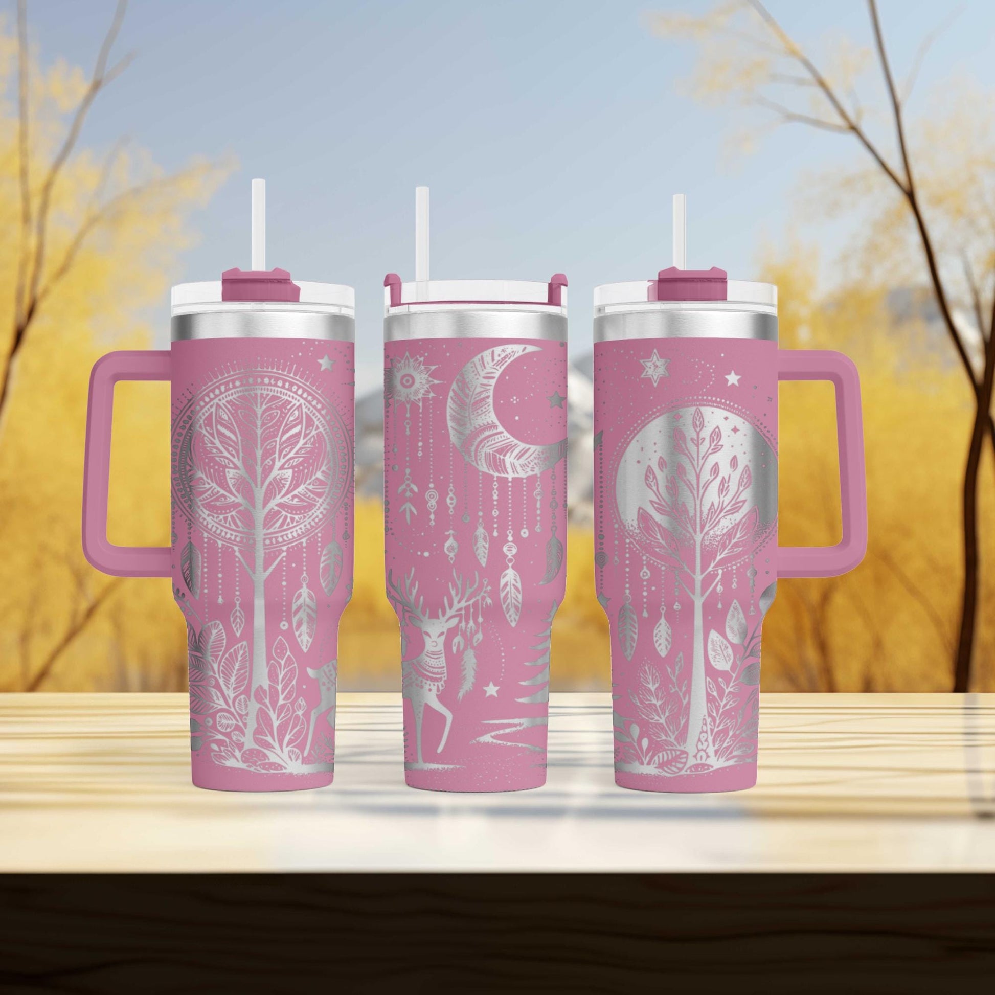 three travel mugs sitting on top of a wooden table