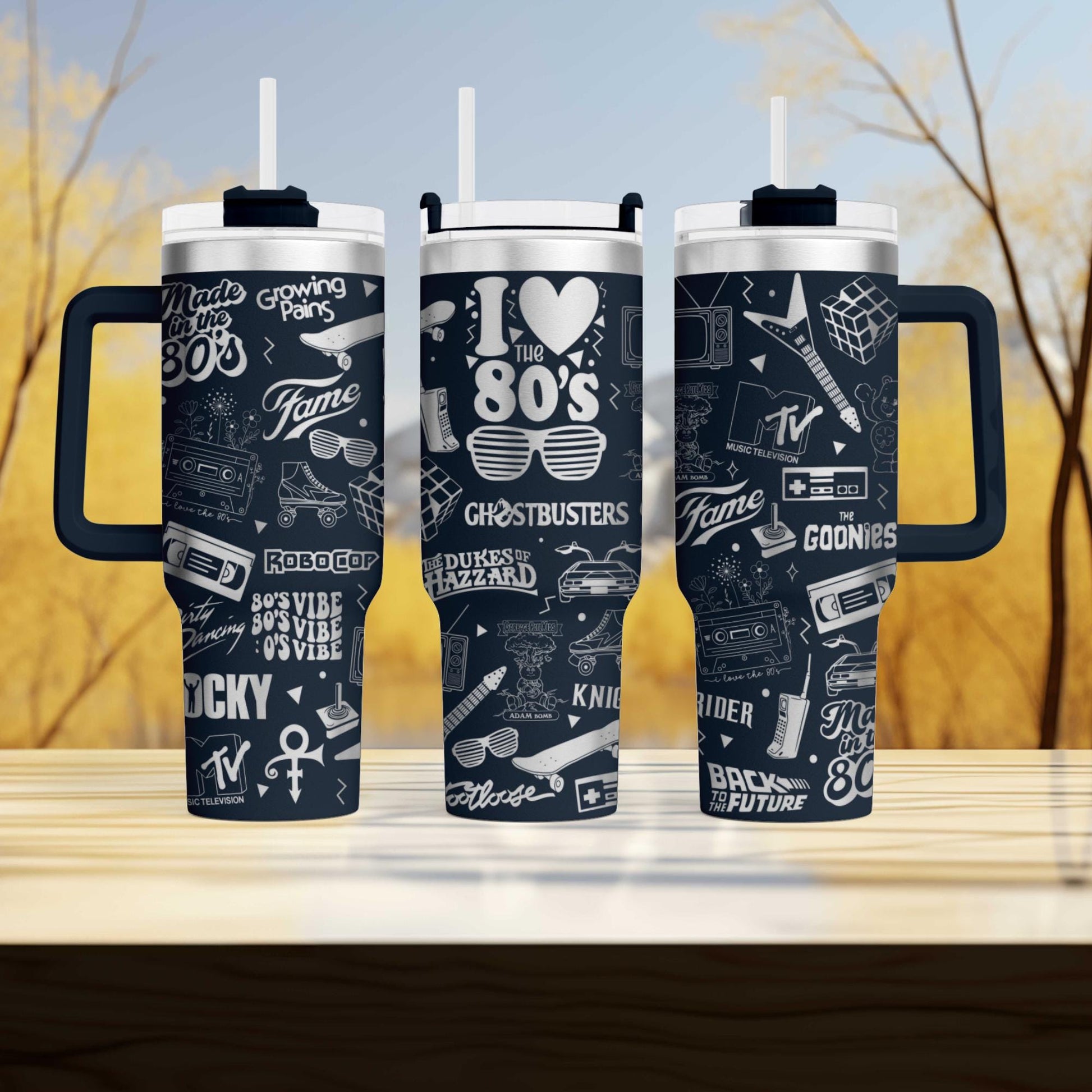 three travel mugs sitting on top of a wooden table