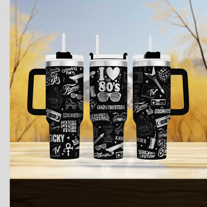 two travel mugs sitting on top of a wooden table