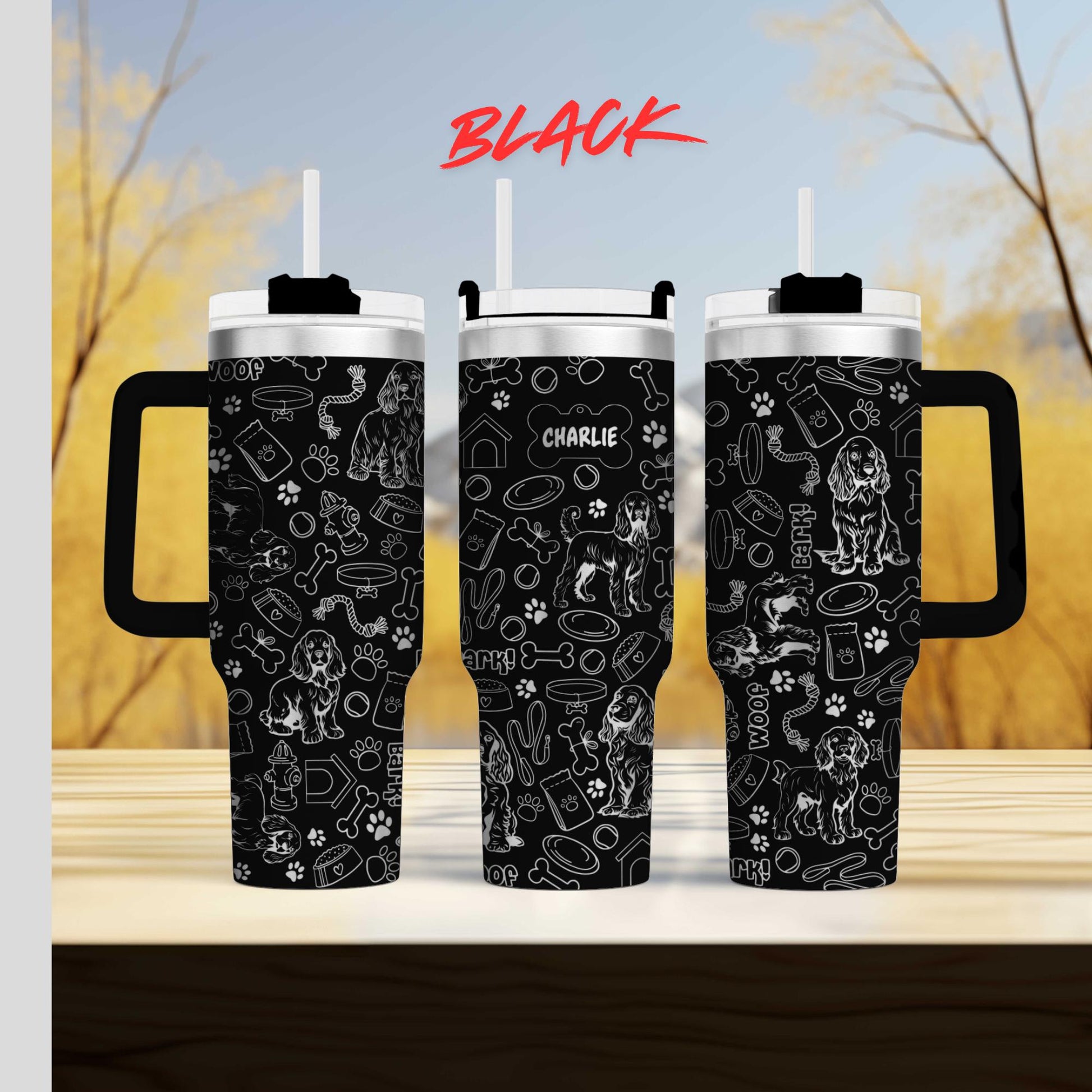 a couple of black coffee mugs sitting on top of a table
