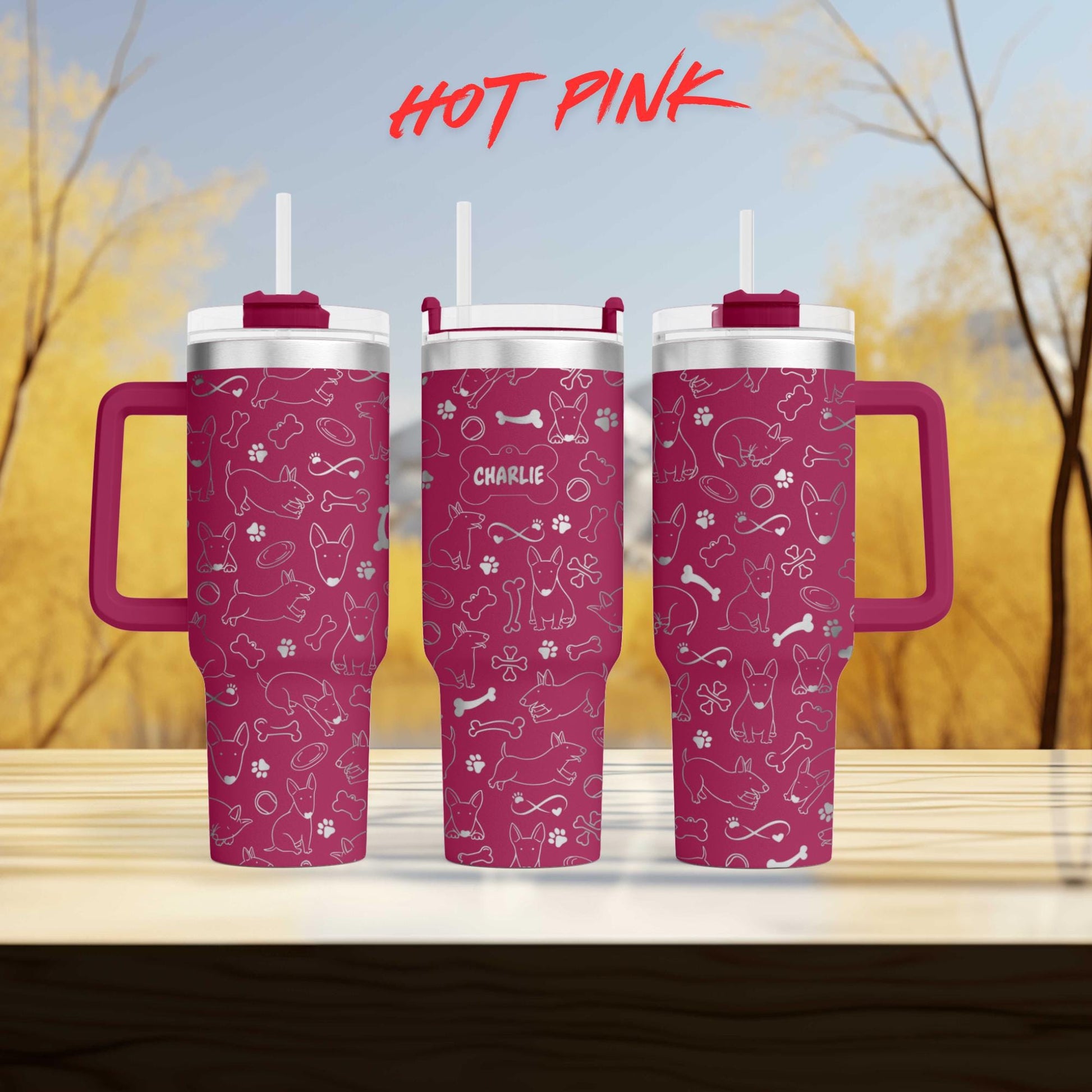 a couple of pink cups sitting on top of a wooden table