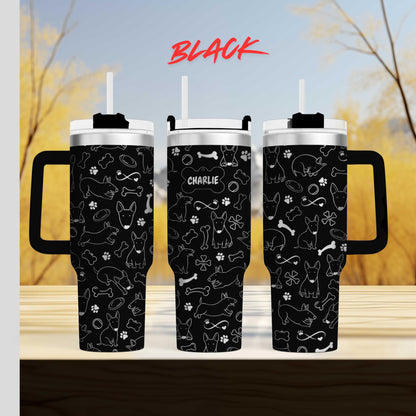 a couple of black cups sitting on top of a wooden table