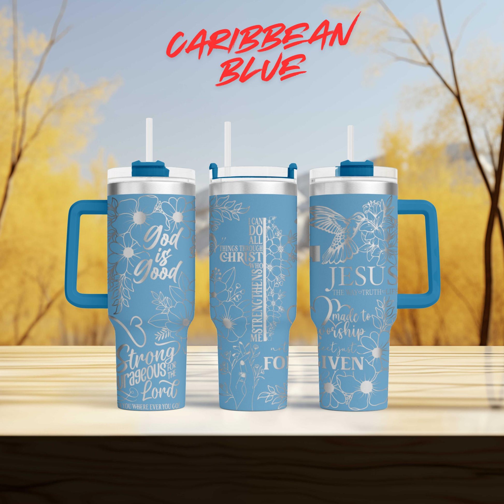 three travel mugs sitting on top of a wooden table