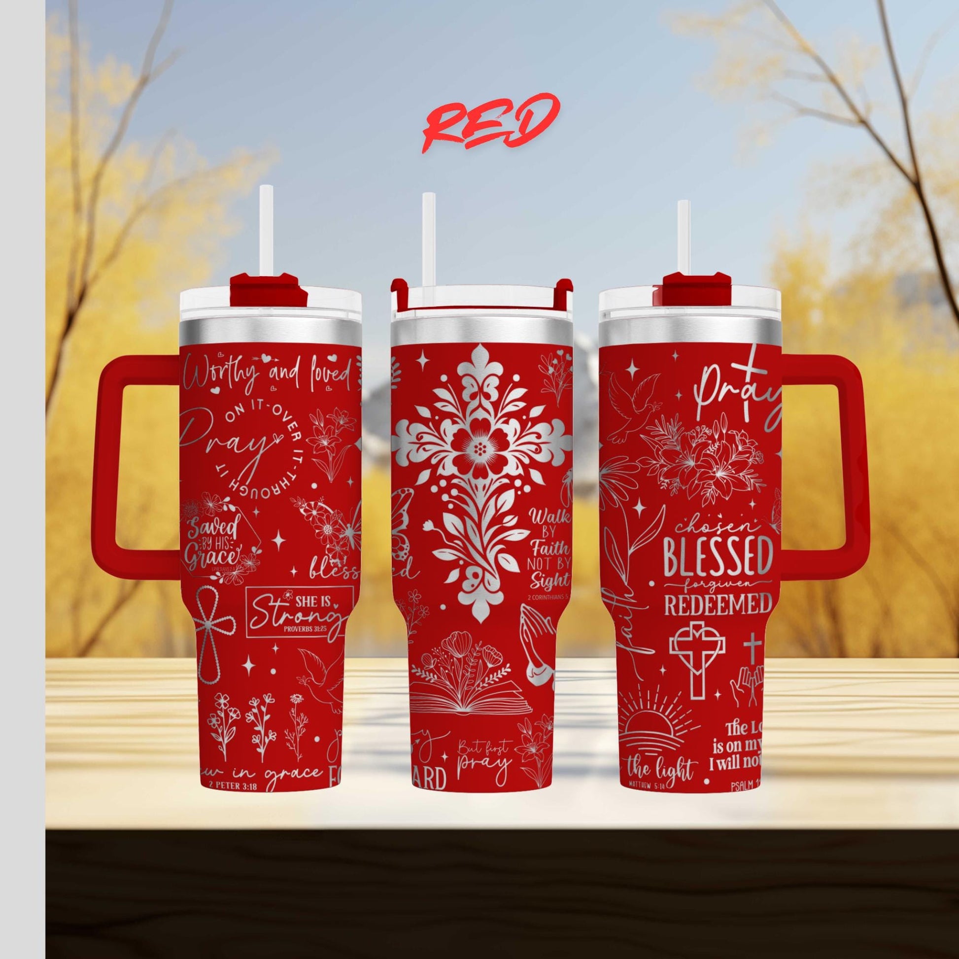three red travel mugs sitting on top of a wooden table