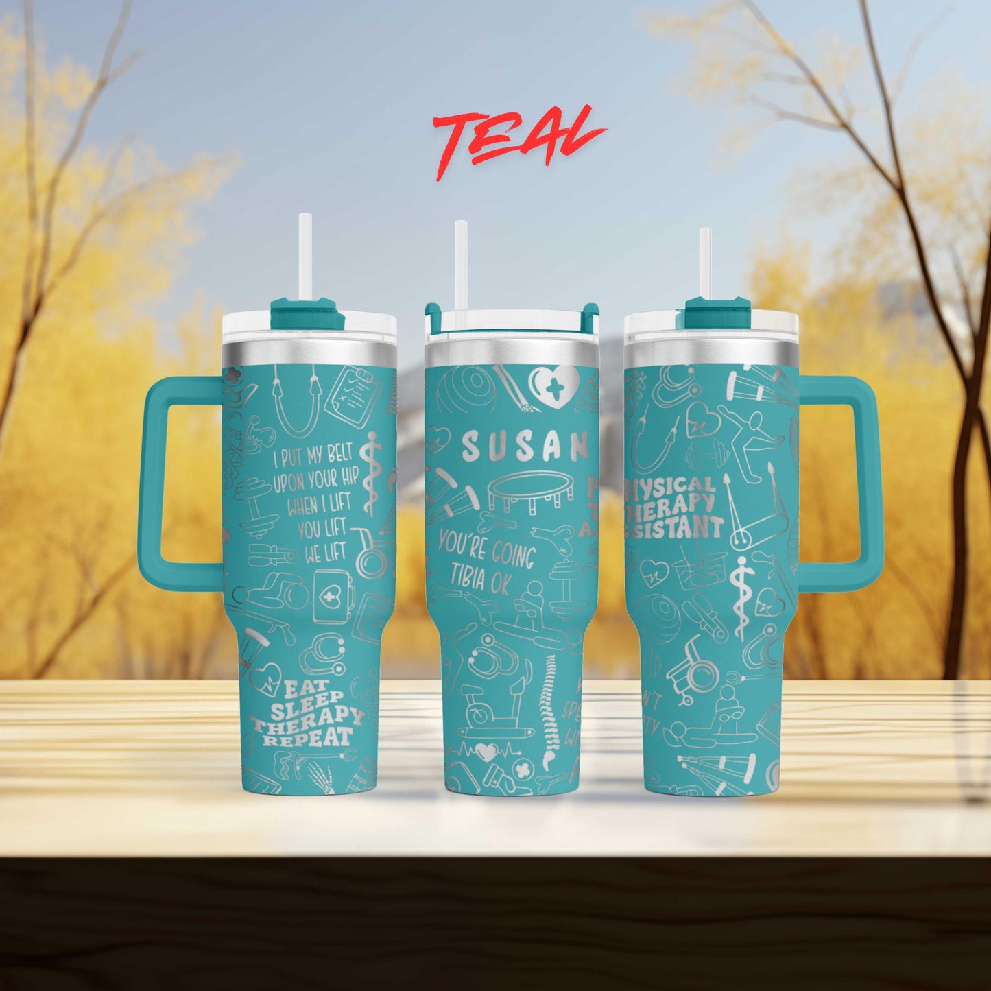 three teal travel mugs sitting on top of a wooden table