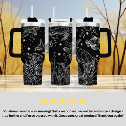 a set of two black and white travel mugs
