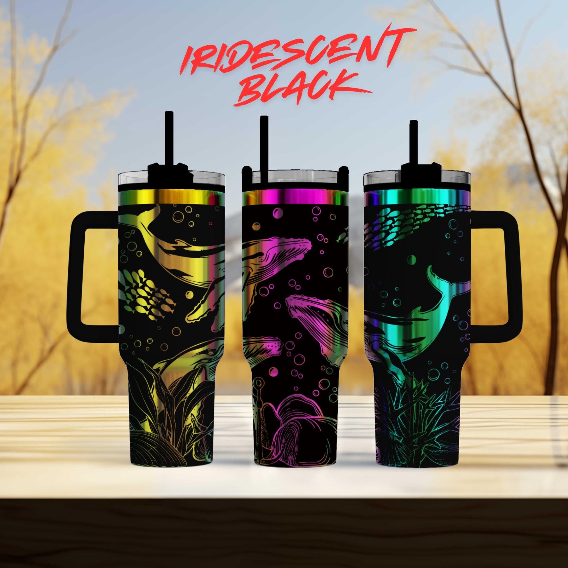 three different colored tumblers sitting on top of a table