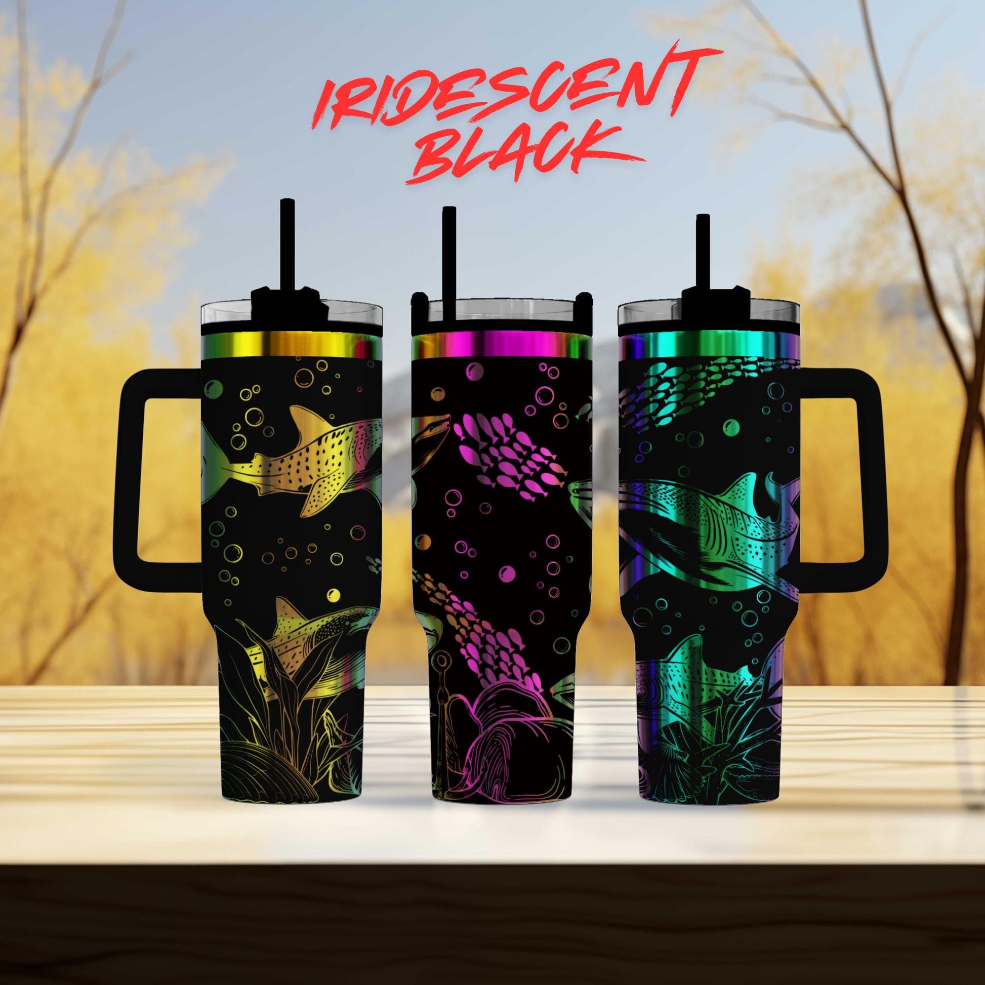 three colorful tumblers sitting on top of a wooden table