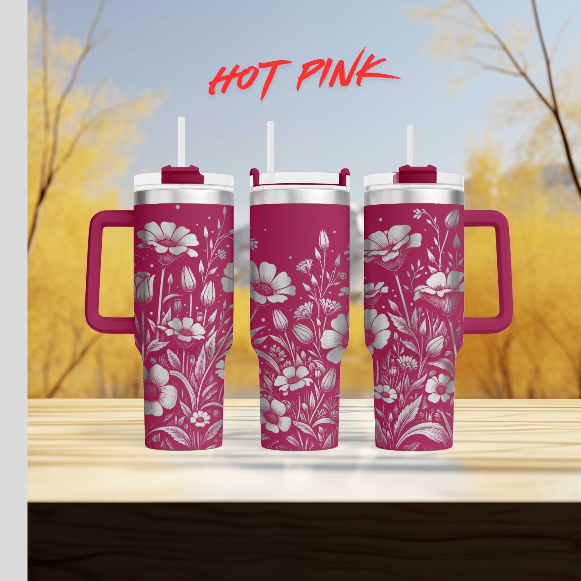 three pink tumblers sitting on top of a wooden table
