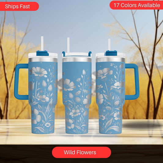 three travel mugs sitting on top of a table