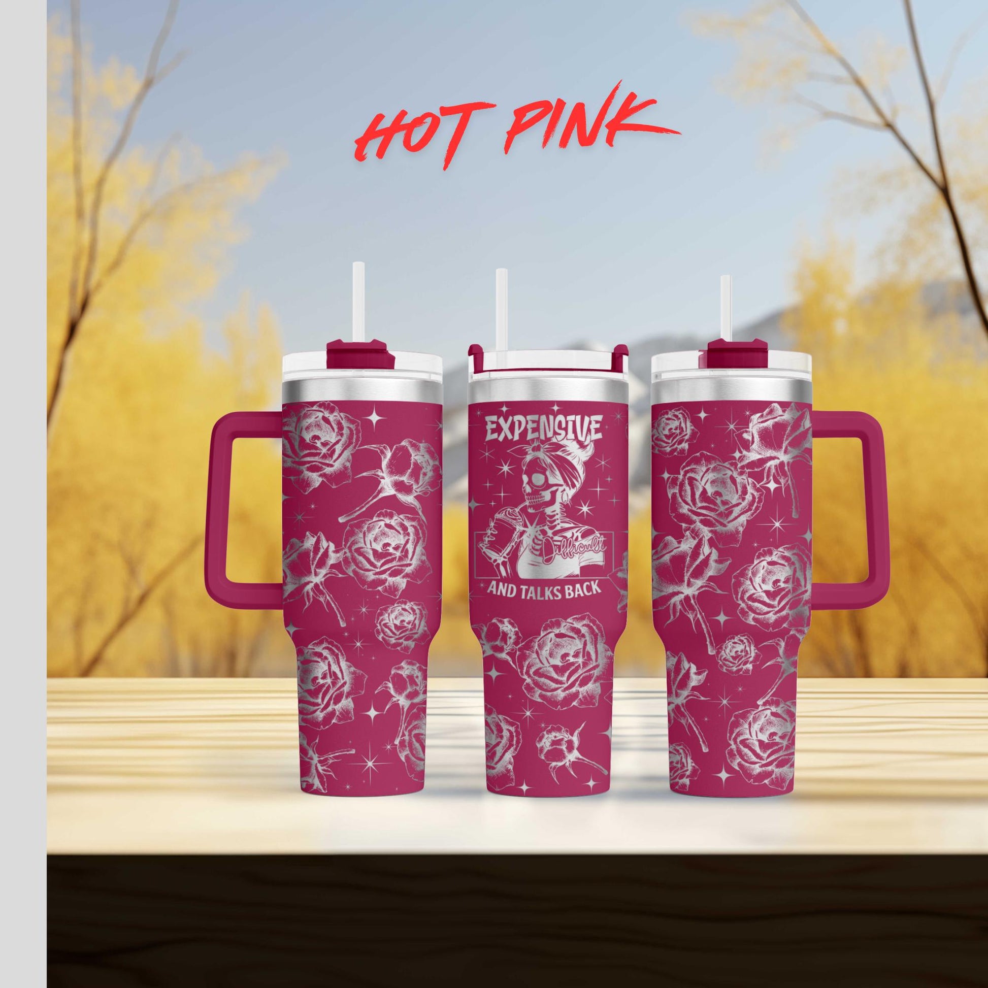 two pink coffee mugs sitting on top of a wooden table