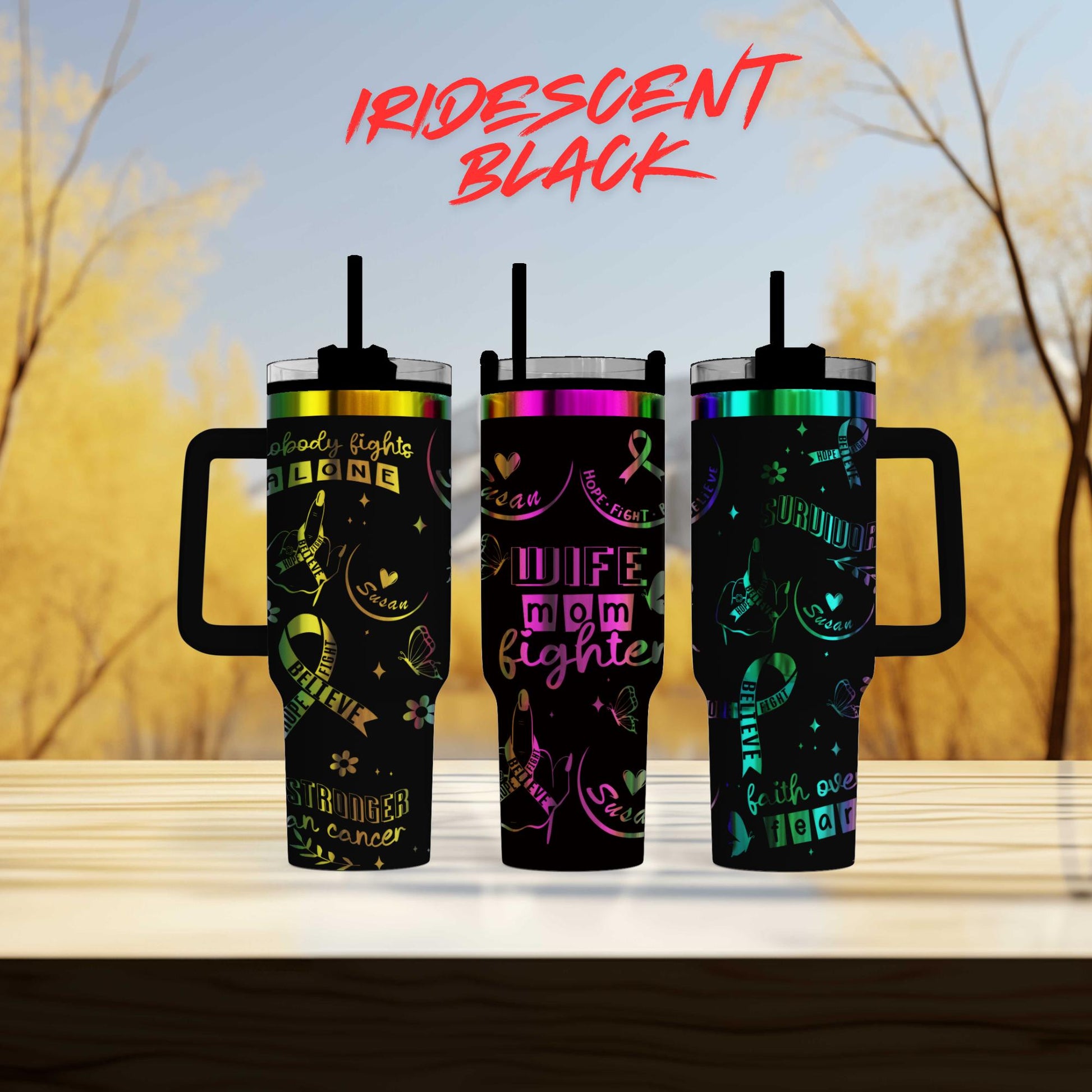 three different colored tumblers sitting on top of a table
