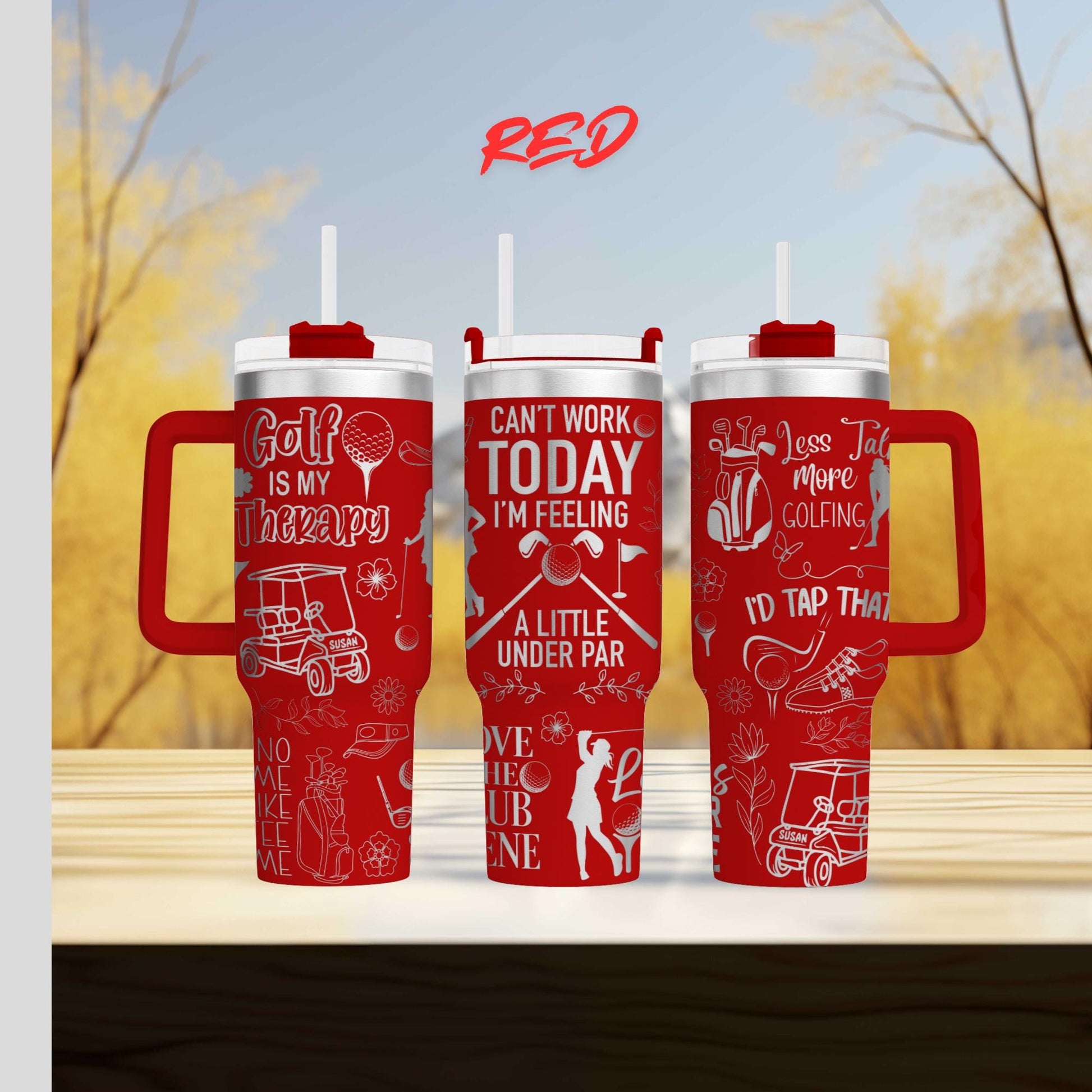 three red travel mugs sitting on top of a wooden table