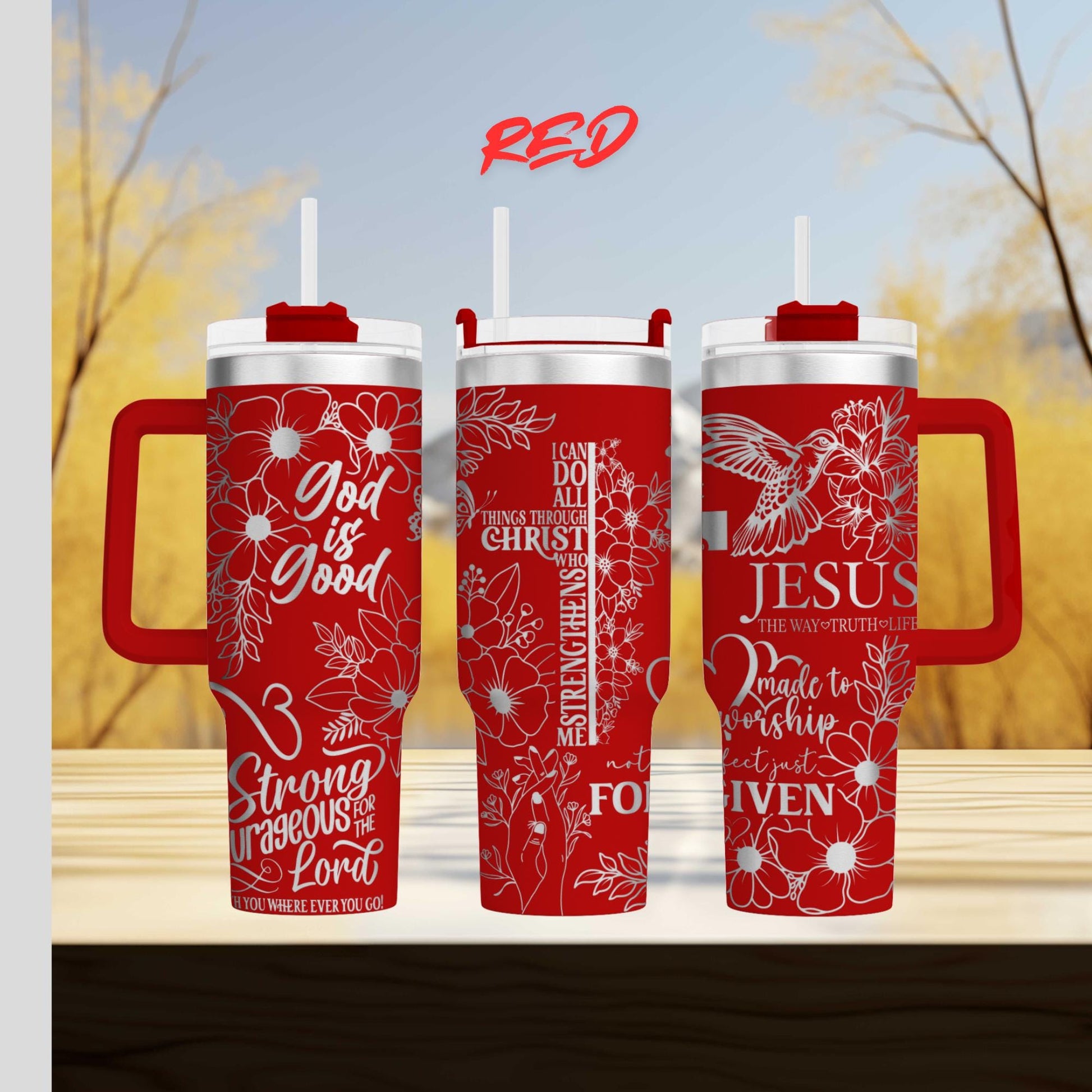 three red travel mugs sitting on top of a wooden table