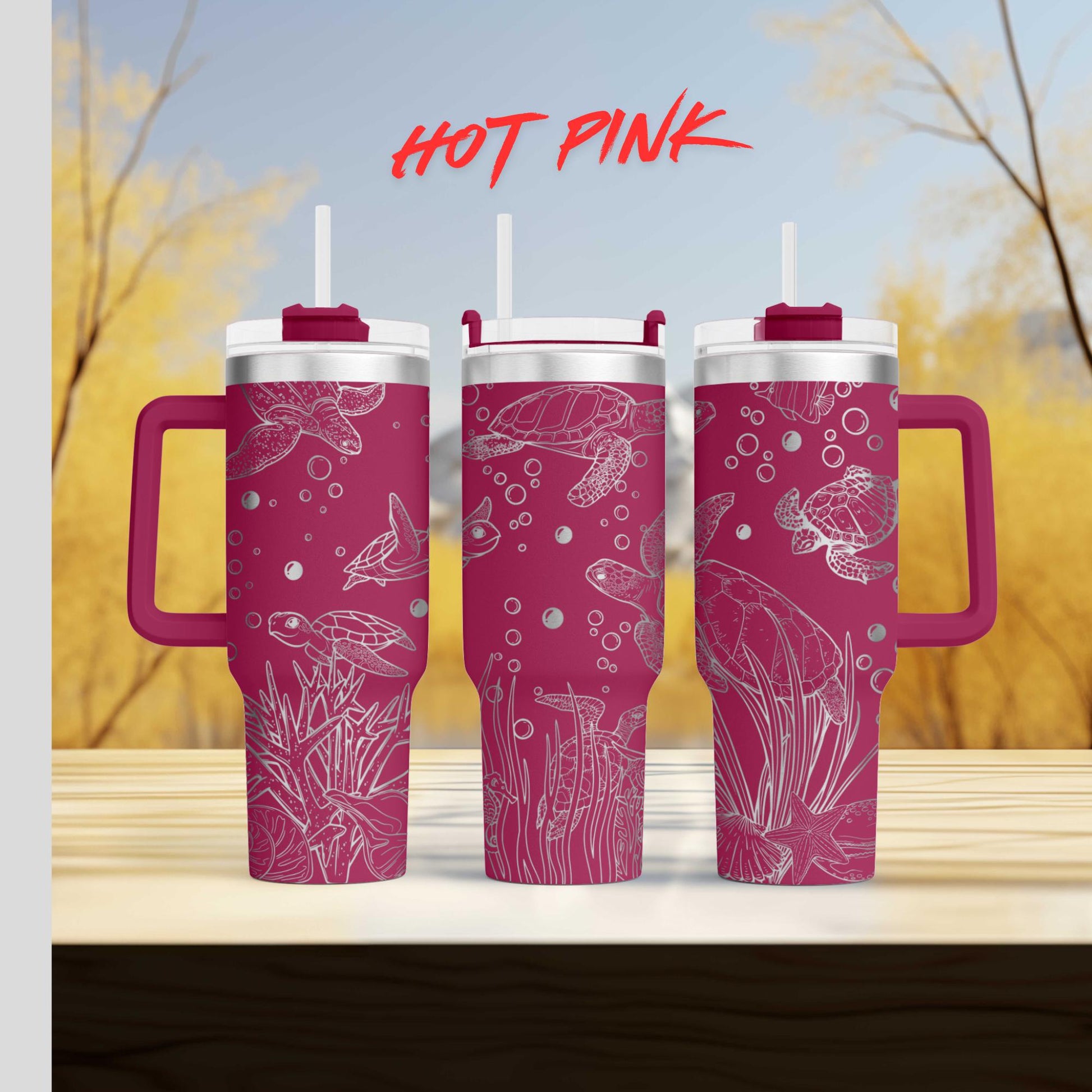 a set of three pink tumblers sitting on top of a wooden table