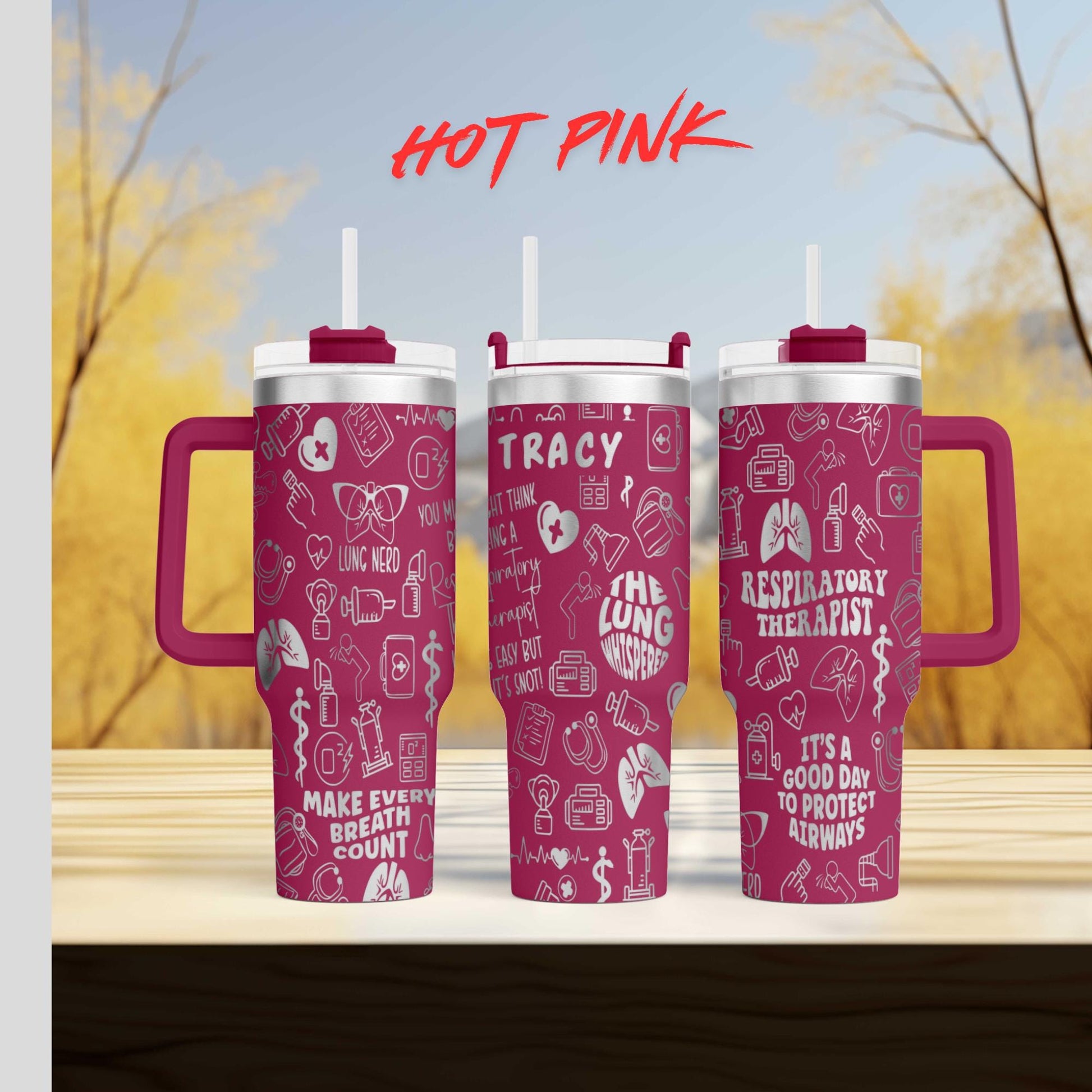 three travel mugs sitting on top of a wooden table