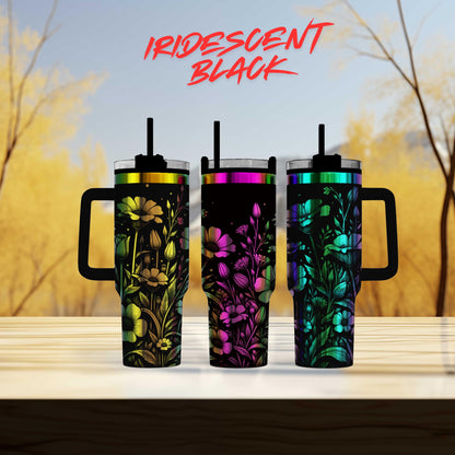 three colorful tumblers sitting on top of a wooden table
