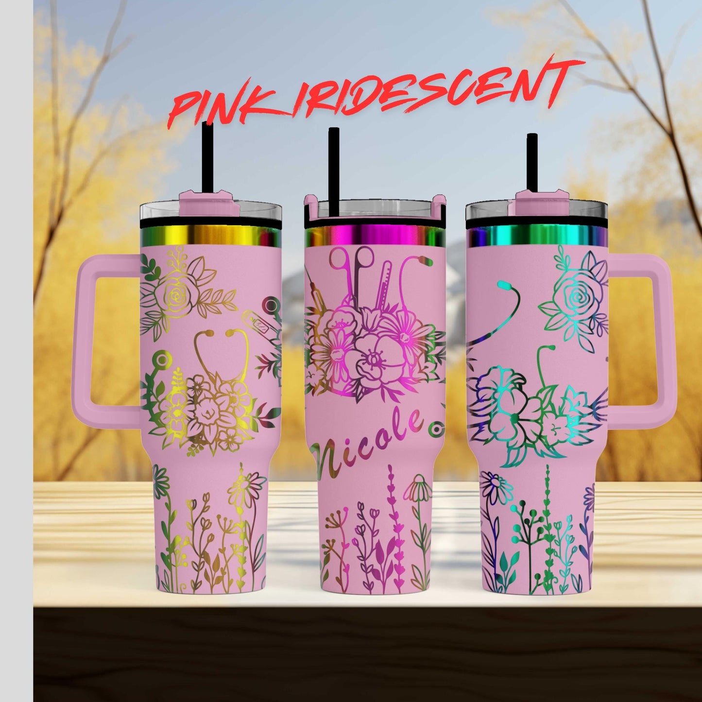 three pink travel mugs sitting on top of a wooden table