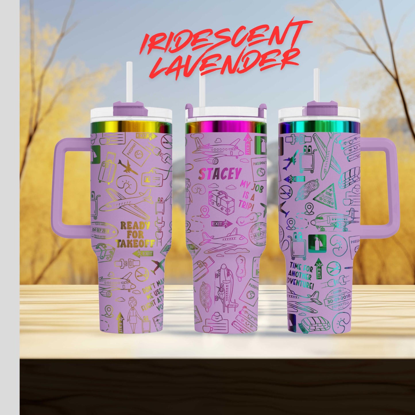 Three colorful stainless steel tumblers with various designs and text printed on them, placed on a wooden surface against a blurred background.