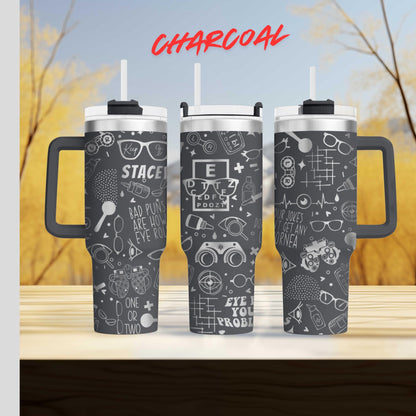 three black and white tumblers with various eye-related designs and text printed on them.