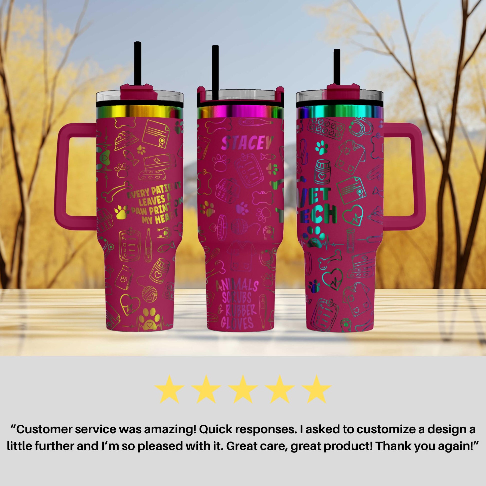 three pink tumblers with colorful designs and straws, placed on a wooden surface against a blurred background of trees.