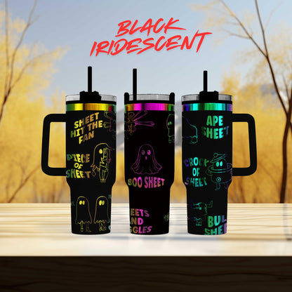 three colorful tumblers with ghost designs on them, set against a blurred background of trees.