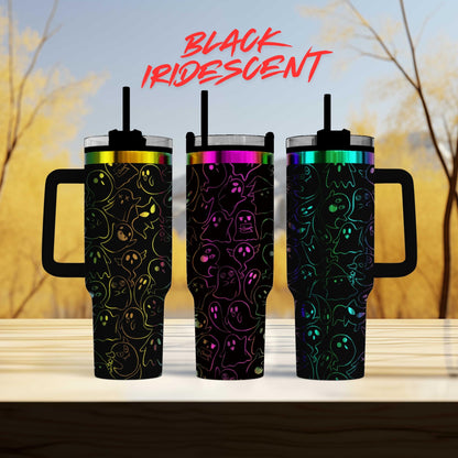three colorful, patterned tumblers with handles, arranged in a row on a wooden surface.