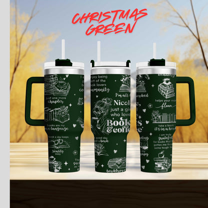 three green tumblers with white text and illustrations on them, set against a blurred background of trees and a blue sky.