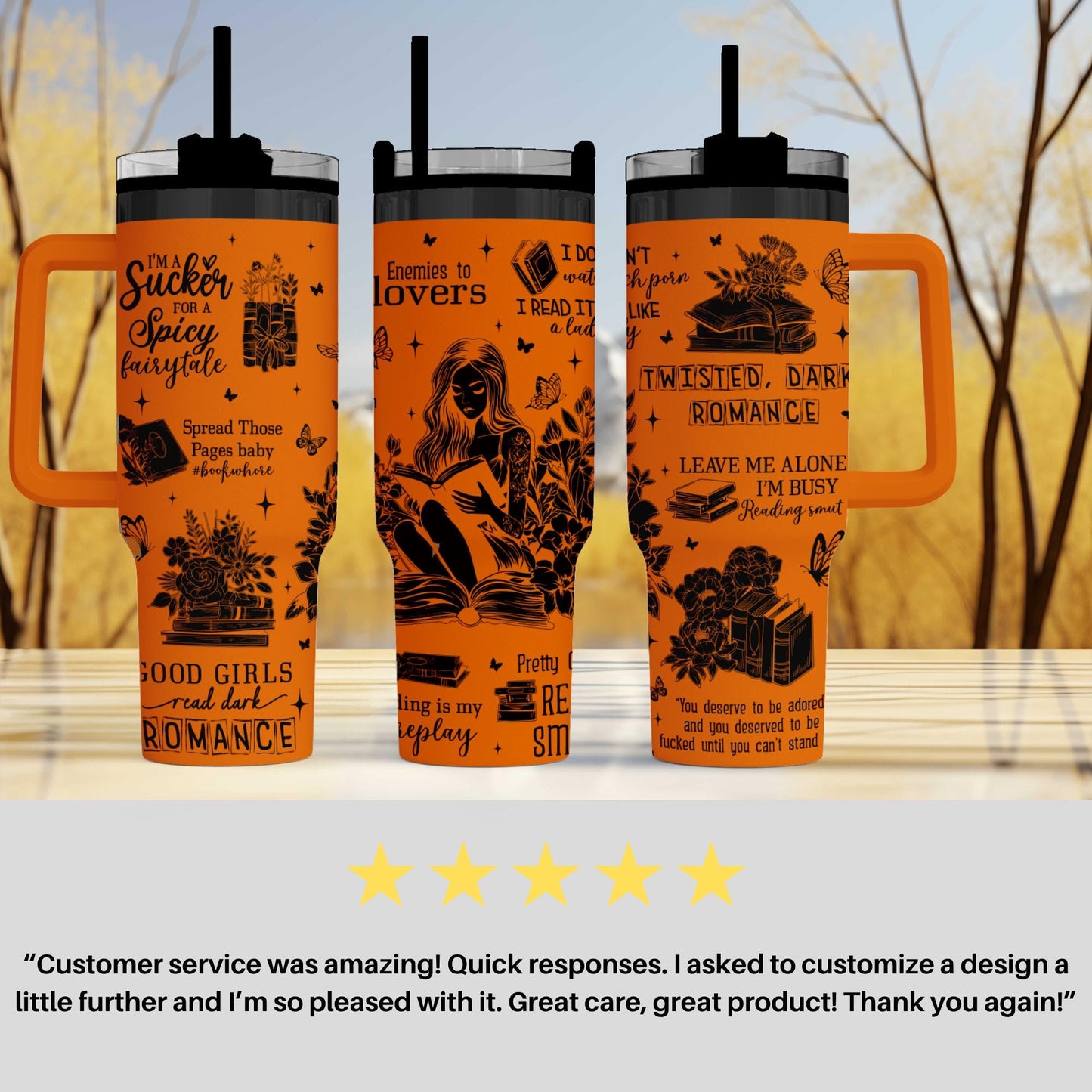 three orange tumblers with black text and illustrations on them. The text includes phrases such as "Suck for a spicy fairy tale", " Enemies to lovers", "Twisted, dark romance", " Leave me alone", and "Reading is my play". The tumblers are displayed on a table, and there is a 5-star rating and a customer review below the image.