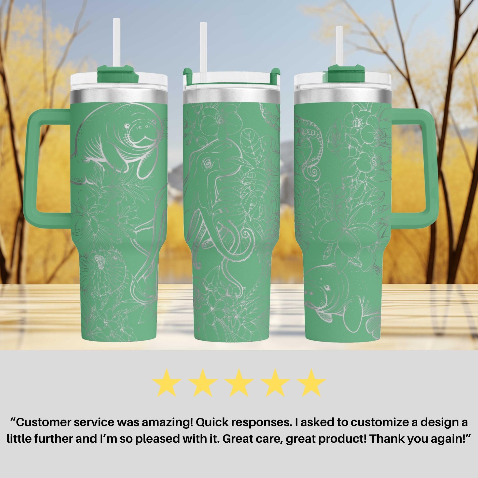 three green tumblers with white designs, including fish and plants, placed on a wooden surface against a blurred background of trees.