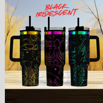 three colorful tumblers with designs of octopi and bubbles on them, set against a blurred background.