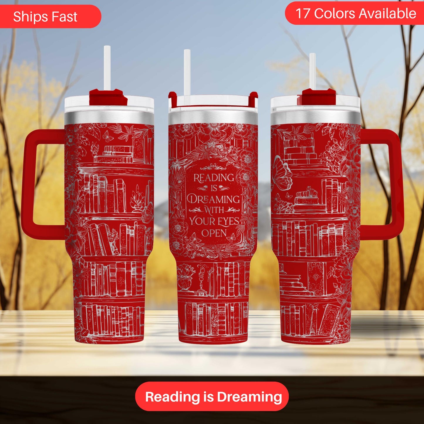 three red insulated tumblers with white text and illustrations of books, set against a blurred background of trees.