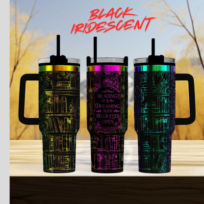 three colorful tumblers with a unique design, including books and other decorative elements.