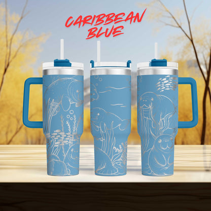 three blue tumblers with illustrations of marine life, including fish, sea creatures, and plants, against a blurred background of trees and sky.