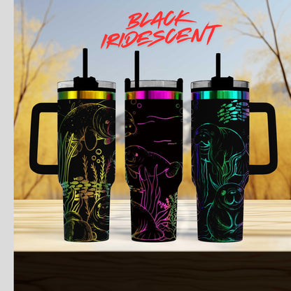 three colorful, patterned tumblers with handles, arranged in a row on a wooden surface.