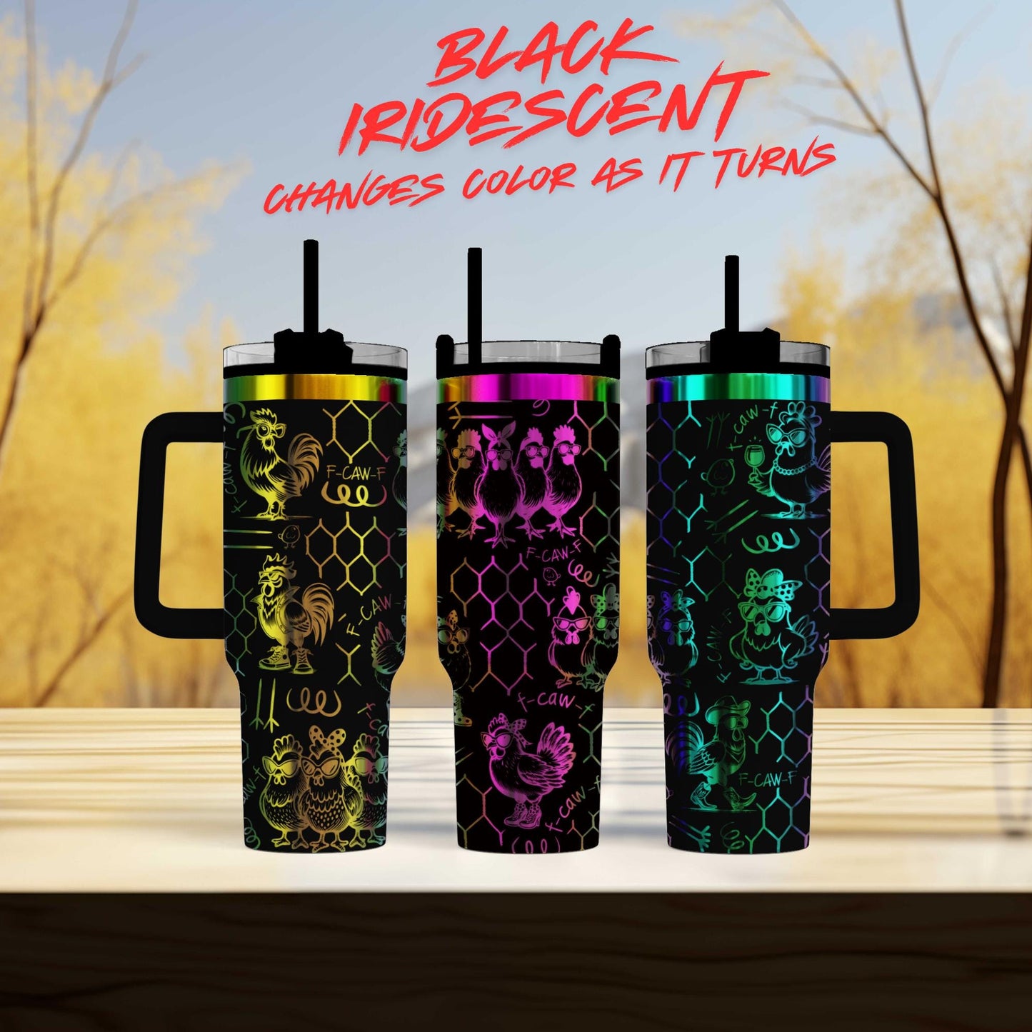 Three colorful stainless steel tumblers with unique designs, placed on a wooden surface against a blurred background of trees.