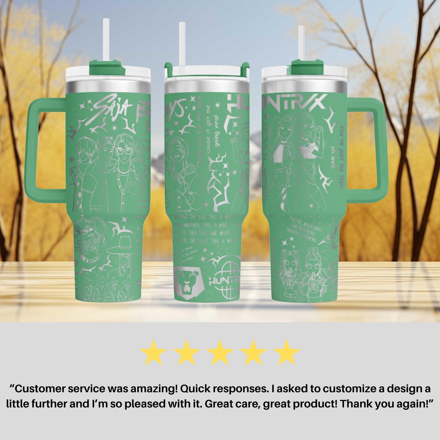three green tumblers with white designs and text, placed on a wooden surface against a blurred background of trees.