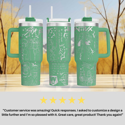 three green tumblers with white designs and text, placed on a wooden surface against a blurred background of trees.