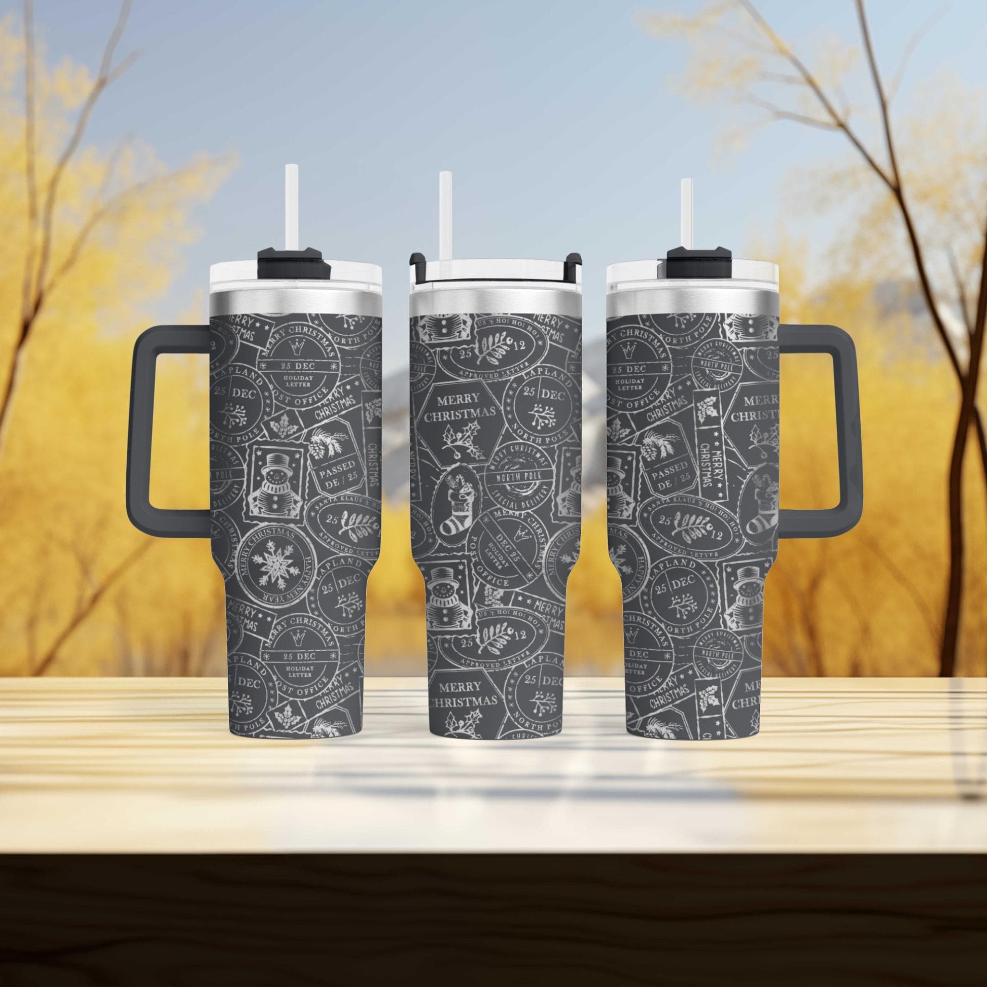 three black and white patterned tumblers with handles, set against a blurred background of trees.